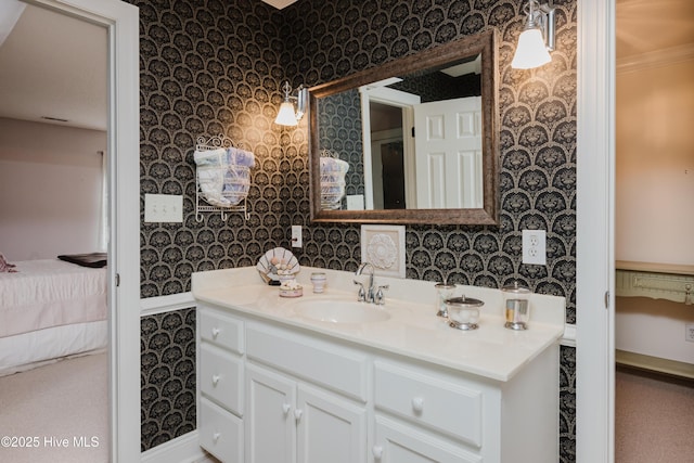 ensuite bathroom with vanity, ensuite bathroom, and wallpapered walls