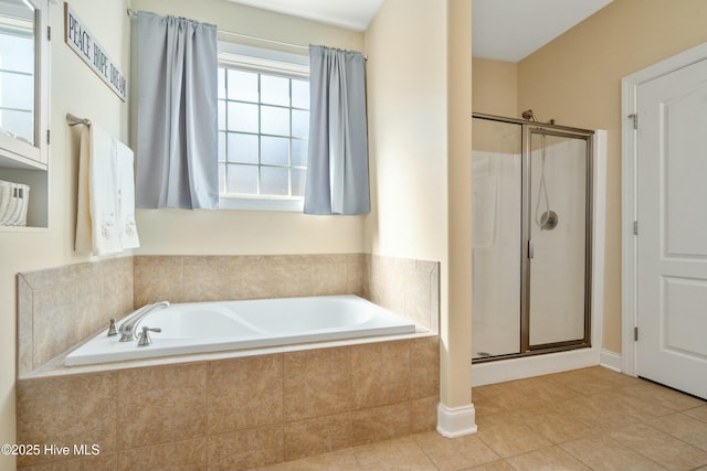 full bathroom featuring a stall shower, tile patterned flooring, and a bath