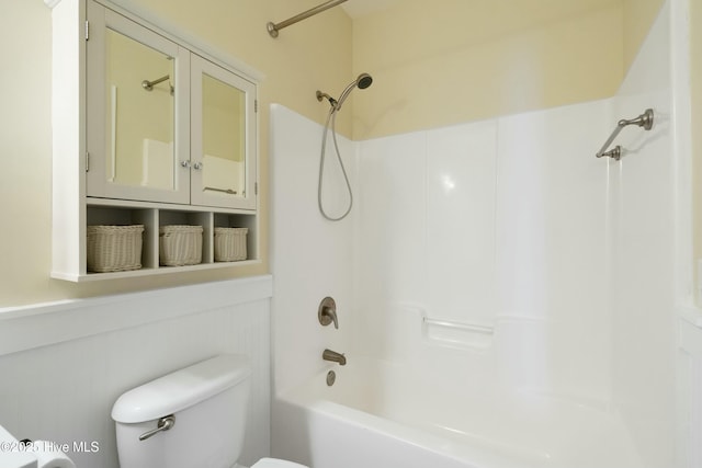 bathroom with bathing tub / shower combination and toilet