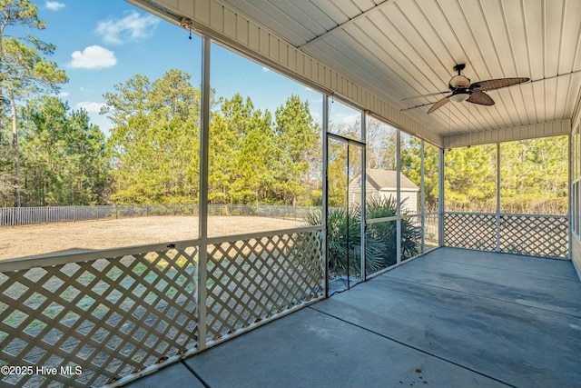 unfurnished sunroom with ceiling fan