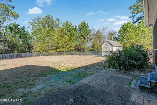 view of yard featuring a patio area, a fenced backyard, an outdoor structure, and a shed