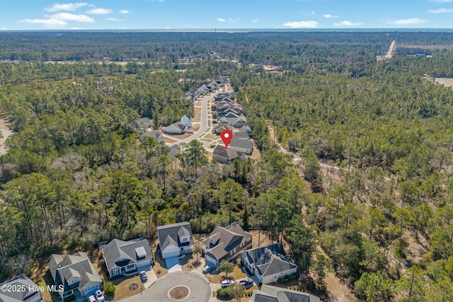 aerial view featuring a wooded view and a residential view