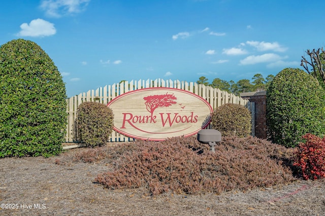 community / neighborhood sign with fence