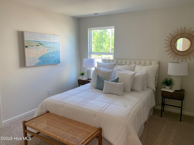 carpeted bedroom featuring baseboards and visible vents