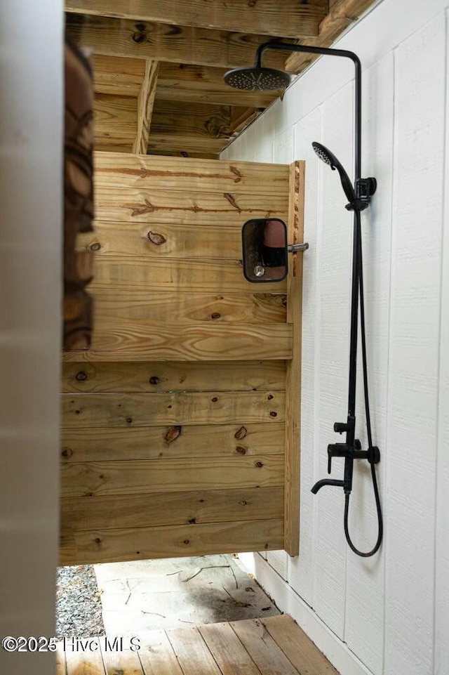 bathroom with a shower and wood finished floors