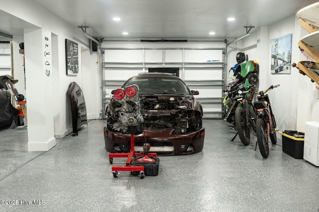 garage with recessed lighting and baseboards