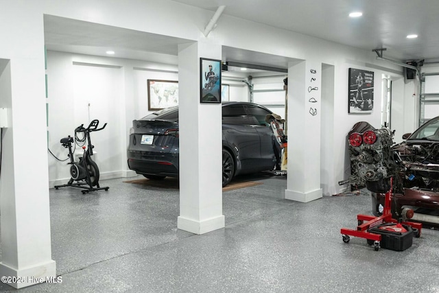 parking deck with recessed lighting and baseboards