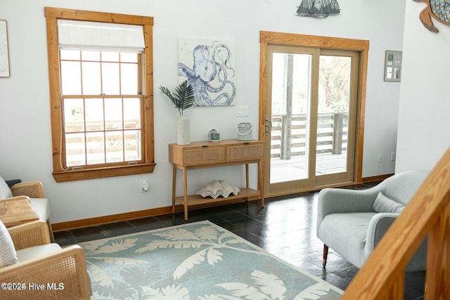 sitting room with dark tile patterned flooring and baseboards