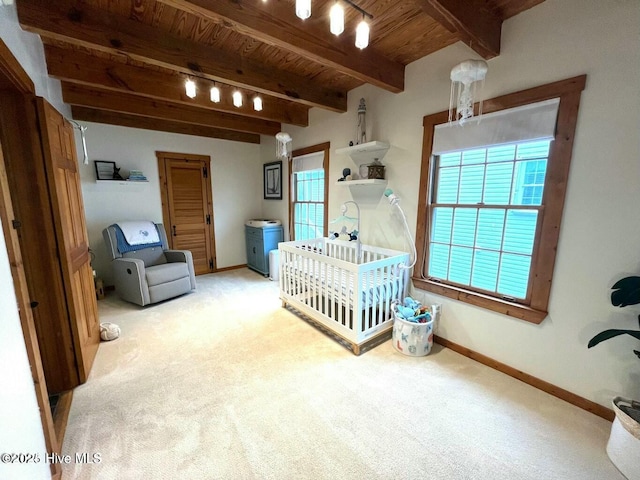 bedroom featuring wood ceiling, light carpet, beamed ceiling, and baseboards