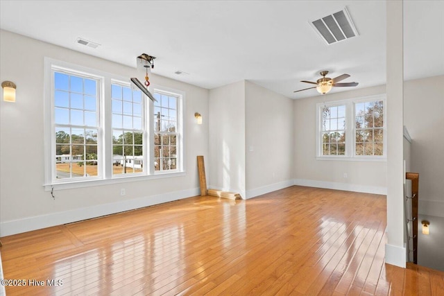 unfurnished living room featuring a ceiling fan, baseboards, visible vents, and light wood finished floors