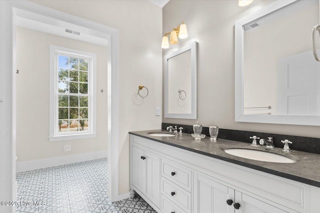 full bathroom with visible vents, a sink, and double vanity