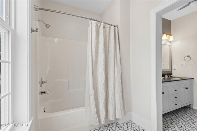 bathroom with shower / tub combo and vanity