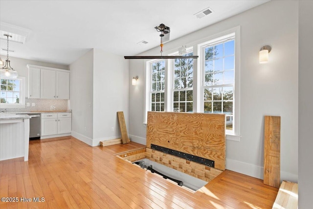 dining room with light wood-style floors, baseboards, and visible vents