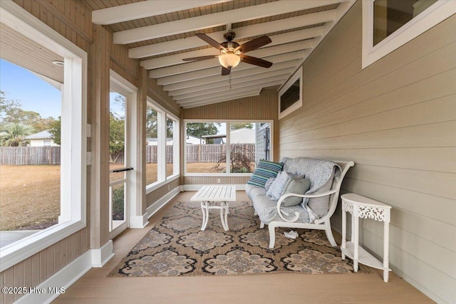 sunroom / solarium featuring vaulted ceiling with beams and ceiling fan