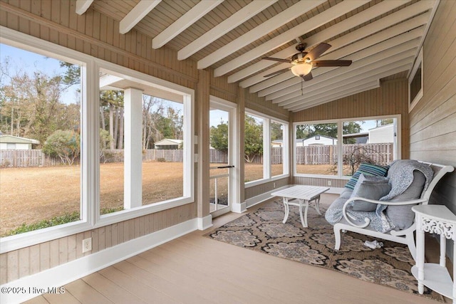 sunroom / solarium with vaulted ceiling with beams and a ceiling fan