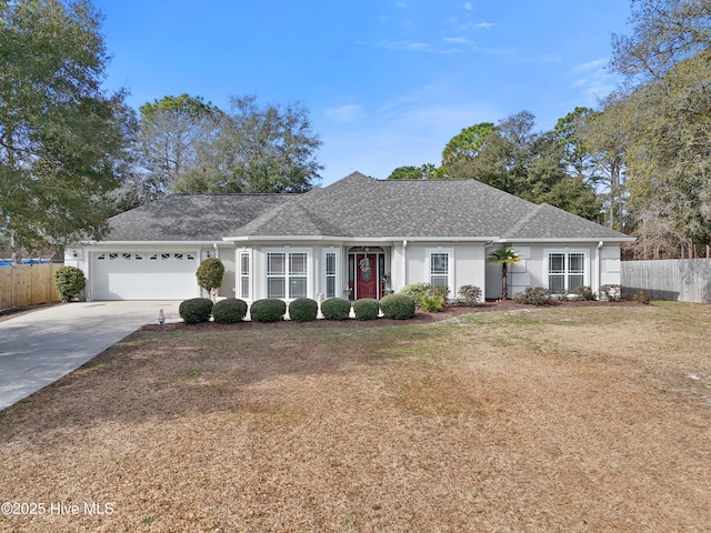 single story home featuring concrete driveway, an attached garage, fence, a front lawn, and stucco siding