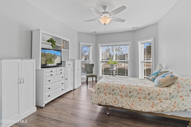 bedroom with visible vents, a ceiling fan, and wood finished floors