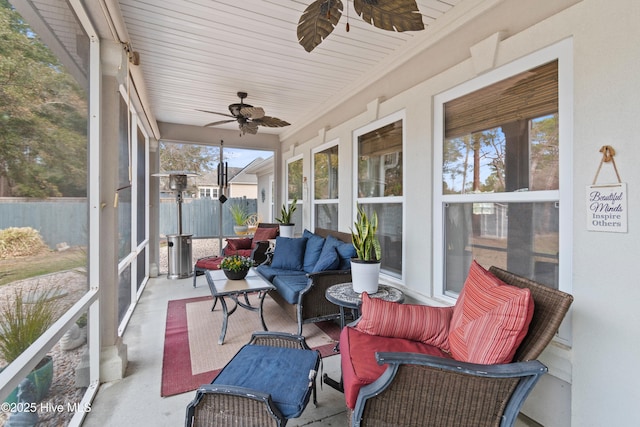 sunroom / solarium with a ceiling fan