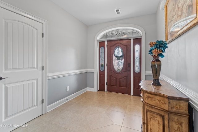 entryway featuring light tile patterned flooring, visible vents, and baseboards