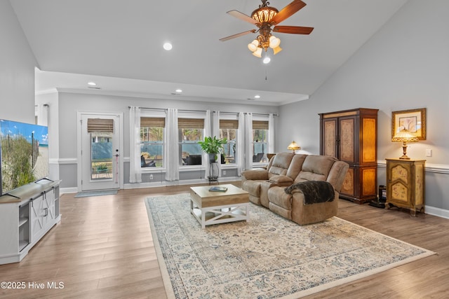 living area featuring baseboards, high vaulted ceiling, recessed lighting, and light wood-style floors