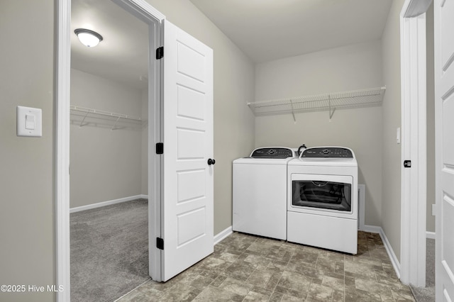 washroom with laundry area, carpet floors, washing machine and dryer, and baseboards