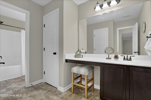 bathroom featuring shower / bath combo with shower curtain, vanity, visible vents, and baseboards