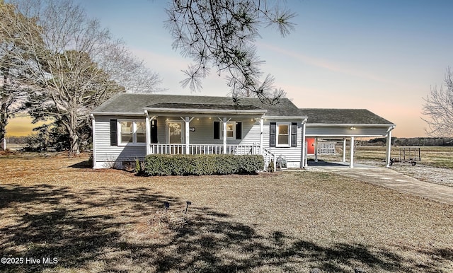 view of front of home with an attached carport, covered porch, concrete driveway, crawl space, and a front yard