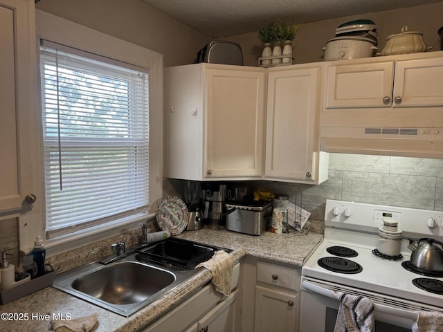 kitchen with light countertops, white electric range, white cabinets, a sink, and under cabinet range hood