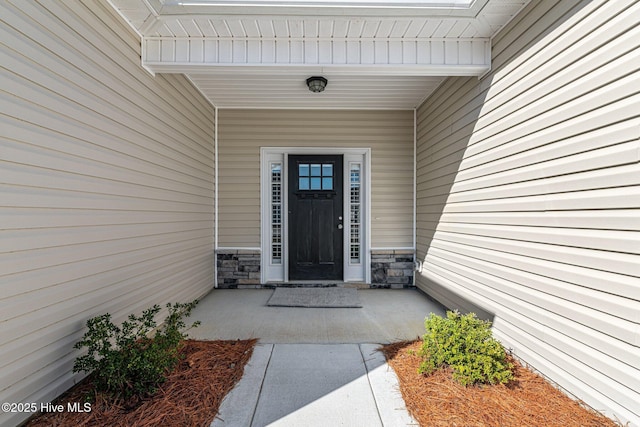 view of exterior entry with stone siding