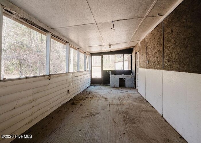 unfurnished sunroom featuring a wealth of natural light