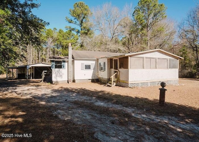 view of front of property featuring a carport