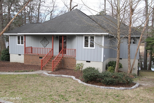 view of front of house with a porch, a shingled roof, crawl space, and a front yard