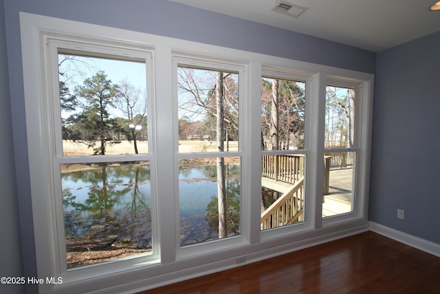 interior space featuring visible vents, hardwood / wood-style flooring, and a wealth of natural light