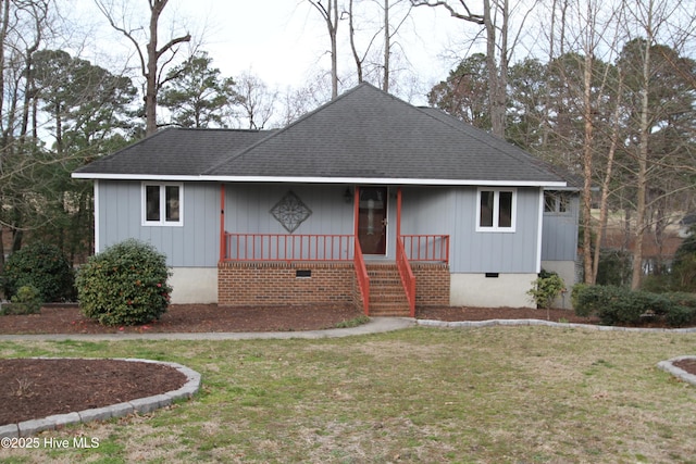 view of front of home with a porch, a front yard, crawl space, and roof with shingles