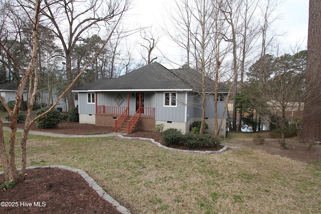 view of front of home featuring covered porch, roof with shingles, a front lawn, and crawl space