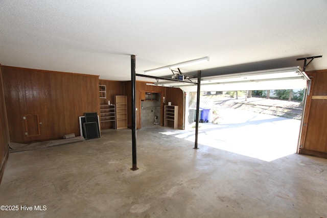 garage featuring wood walls and a garage door opener