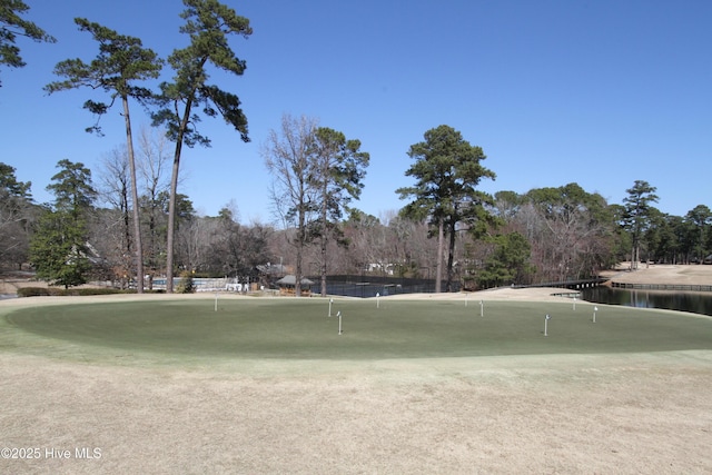 surrounding community featuring view of golf course and a water view