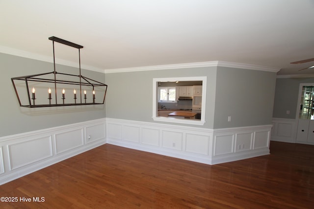 unfurnished room with wood finished floors and crown molding