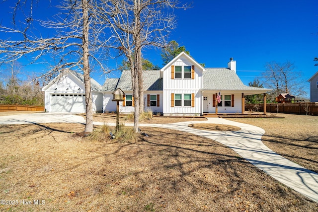 modern inspired farmhouse with a shingled roof, concrete driveway, a chimney, fence, and board and batten siding