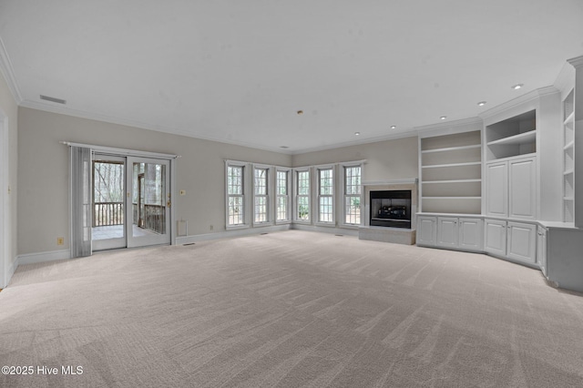 unfurnished living room featuring a fireplace with raised hearth, light carpet, visible vents, baseboards, and ornamental molding