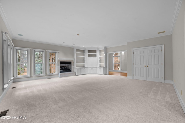 unfurnished living room featuring light carpet, baseboards, visible vents, a fireplace with raised hearth, and ornamental molding