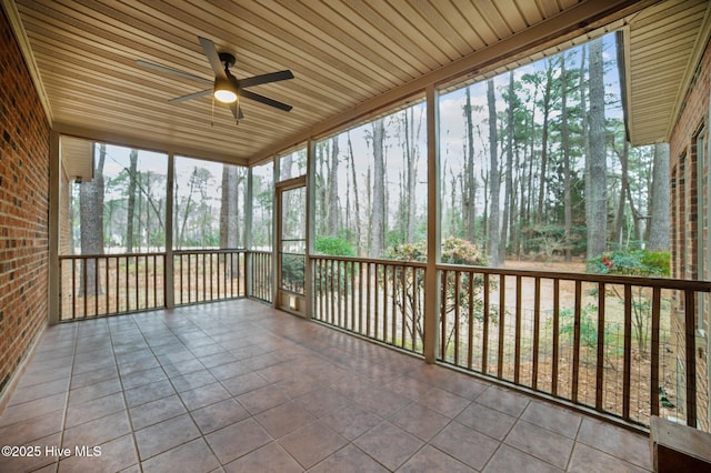 unfurnished sunroom with a ceiling fan