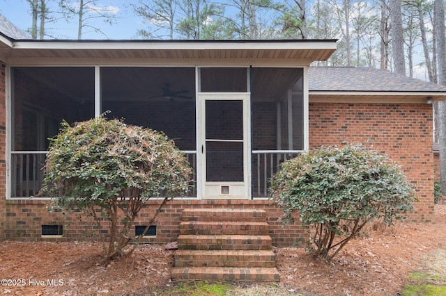 entrance to property featuring brick siding and crawl space