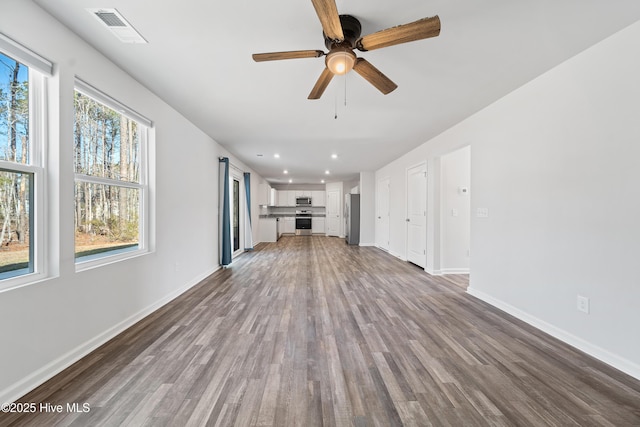 unfurnished living room featuring ceiling fan, recessed lighting, visible vents, baseboards, and light wood finished floors