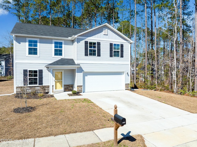 view of front of home with driveway, a garage, stone siding, a front lawn, and board and batten siding