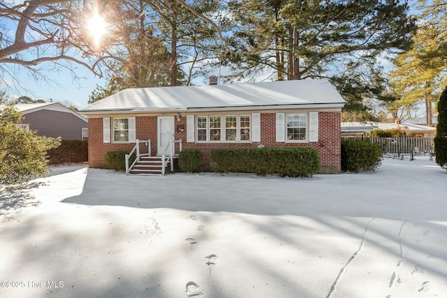 single story home with brick siding and fence