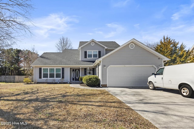 traditional home featuring a shingled roof, fence, a garage, driveway, and a front lawn