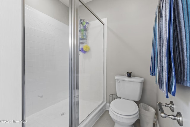 bathroom with a stall shower and toilet