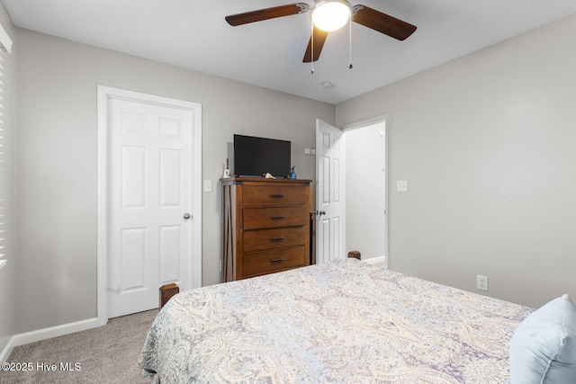 bedroom with baseboards, a ceiling fan, and light colored carpet