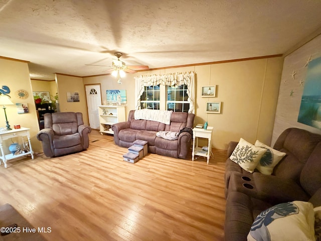 living area with crown molding, a textured ceiling, light wood finished floors, and ceiling fan